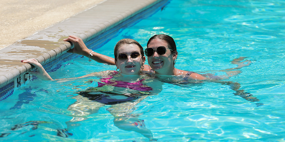 girls smiling in the pool